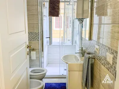 a bathroom with a toilet and a sink and a shower at Azadi B&B Flaminio in Rome