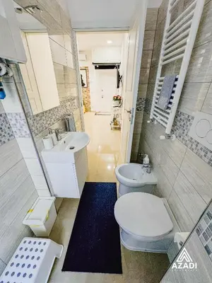 a small bathroom with a toilet and a sink at Azadi B&B Flaminio in Rome