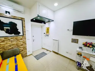 a living room with a flat screen tv on the wall at Azadi B&B Flaminio in Rome