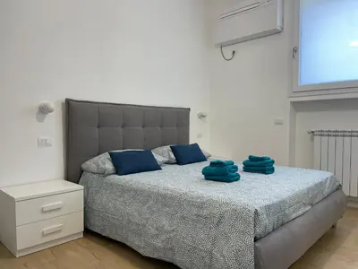 a bedroom with a bed with blue towels on it at [COLOSSEUM] Latin Romans Apartments in Rome