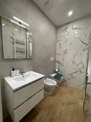 a bathroom with a white sink and a toilet at [COLOSSEUM] Latin Romans Apartments in Rome