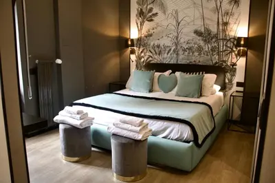a hotel room with a bed with towels on it at XCross Suites Roma in Rome