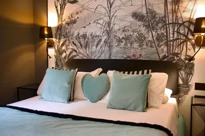a bed with two pillows with a heart on it at XCross Suites Roma in Rome
