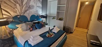 a bedroom with a blue and white bed with a plate of food at XCross Suites Roma in Rome