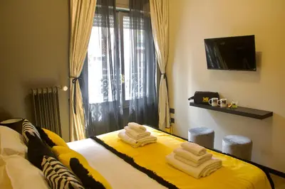 a hotel room with a bed with towels on it at XCross Suites Roma in Rome