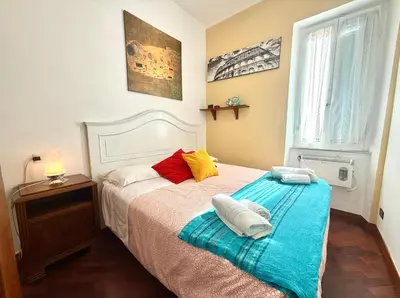 a bedroom with a bed with two towels on it at 3 min da Stazione San Pietro in Rome