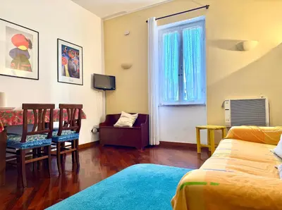 a bedroom with a bed and a table and chairs at 3 min da Stazione San Pietro in Rome