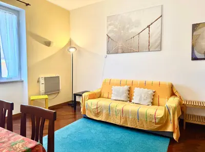 a living room with a yellow couch in a room at 3 min da Stazione San Pietro in Rome