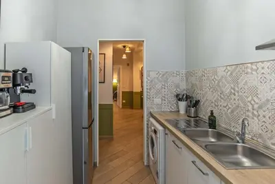 a kitchen with a sink and a refrigerator at Ary's Vatican Holiday Home in Rome