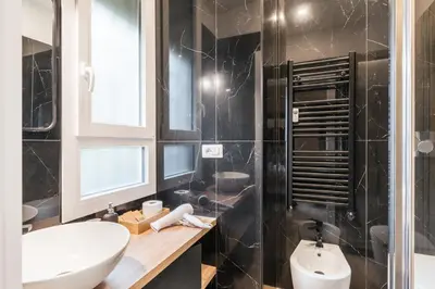 a bathroom with a white sink and a toilet at Italy House in Rome