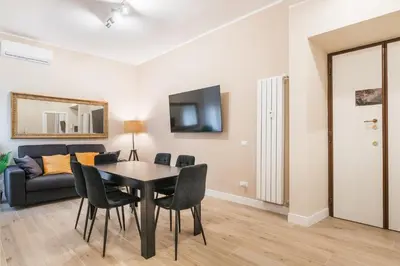 a living room with a table and chairs and a couch at Italy House in Rome