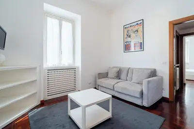 a living room with a couch and a table at Art House Vaticano Apartment in Rome