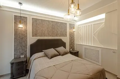 a bedroom with a large bed and two night stands at Bed & Breakfast Il Narciso in Rome