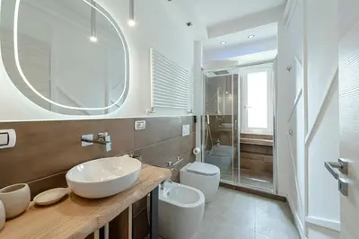a bathroom with two sinks and a toilet and a mirror at Bed & Breakfast Il Narciso in Rome