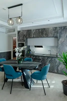 a dining room with a table and blue chairs at Bed & Breakfast Il Narciso in Rome