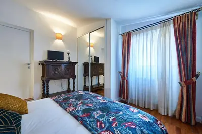 a bedroom with a bed and a large window at La Dolce Vita Rooftop Suite in Rome