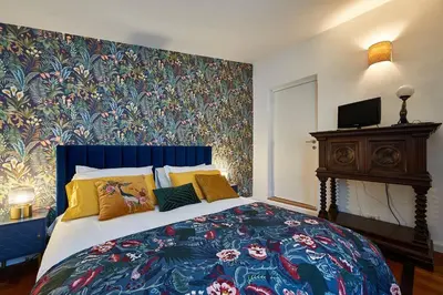 a bedroom with a large bed with a floral wallpaper at La Dolce Vita Rooftop Suite in Rome