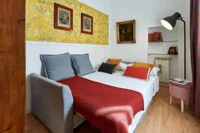 a bedroom with a bed with a red blanket on it at La Dolce Vita Rooftop Suite in Rome