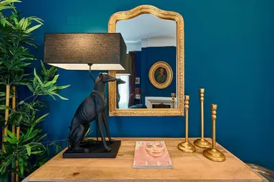 a table with a lamp and a mirror on it at La Dolce Vita Rooftop Suite in Rome