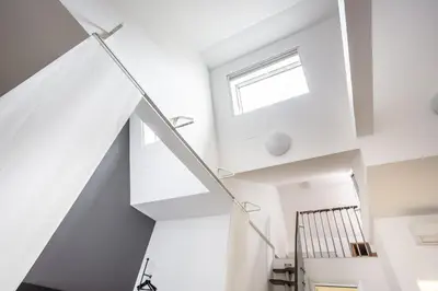 a white staircase in a house with a window at Trastevere Double A LOFT in Rome