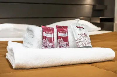 a pile of towels and toothbrushes on a bed at Trastevere Double A LOFT in Rome
