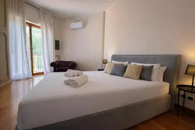 a bedroom with a large white bed with towels on it at èROMA - SAN PAOLO BASILICA Apartment in Rome