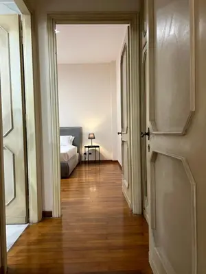 a hallway with a bed and an open door at èROMA - SAN PAOLO BASILICA Apartment in Rome