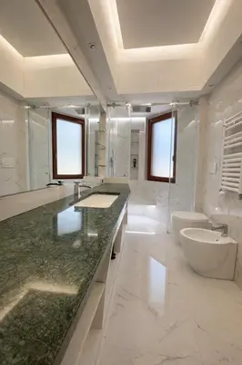 a white bathroom with a sink and a toilet at èROMA - SAN PAOLO BASILICA Apartment in Rome