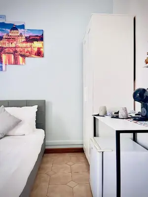 a bedroom with a white bed and a desk at Rome Room Vatican in Rome