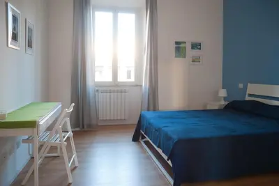 a bedroom with a bed and a desk and a window at Welcome Friends in Rome