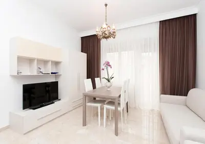 a white living room with a table and a couch at Residenza dei Pontefici in Rome