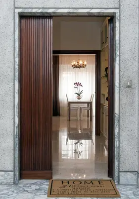 a door leading into a dining room with a table at Residenza dei Pontefici in Rome