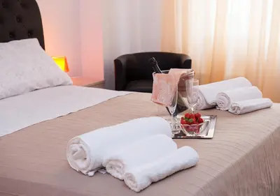 a bed with towels and a glass of wine on it at Residenza dei Pontefici in Rome