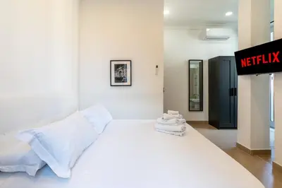 a white bed with white sheets and towels on it at San Giovanni Boutique Suites in Rome