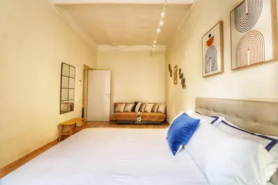 a bedroom with a large bed and a couch at Lovely 2 Bedroom apartment by YourHost in Rome