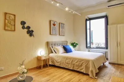 a bedroom with a bed and a window at Lovely 2 Bedroom apartment by YourHost in Rome