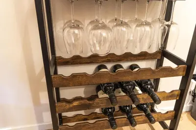a wine rack with wine glasses and wine bottles at Cunabu Urbano in Rome