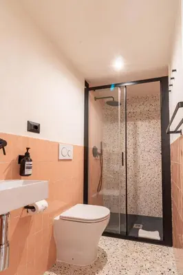 a bathroom with a toilet and a shower at Cunabu Urbano in Rome