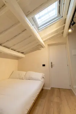 a bedroom with a white bed and a window at Cunabu Urbano in Rome