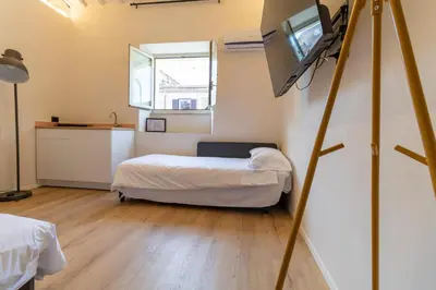 a room with a bed and a television in it at Cunabu Urbano in Rome