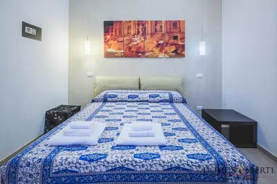 a bedroom with a bed with two pillows on it at Domus Alberti Bed & Breakfast in Rome
