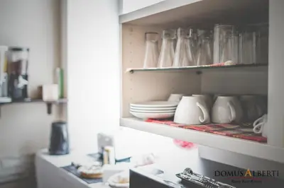 a cupboard filled with plates and cups and dishes at Domus Alberti Bed & Breakfast in Rome