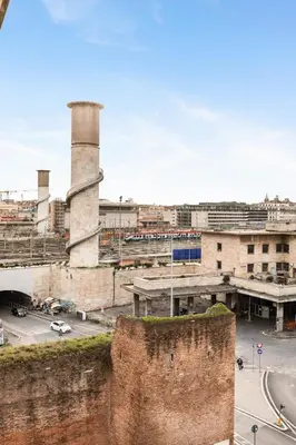 an old factory with a brick wall and a street at Termini Station Lightsome 3BR Apartment in Rome