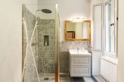 a bathroom with a shower and a sink and a mirror at Monti Charming Amphora Apartment in Rome