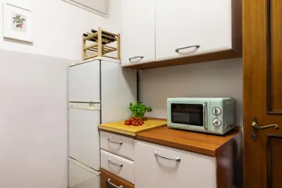 a kitchen with a microwave on top of a counter at Monti Charming Amphora Apartment in Rome