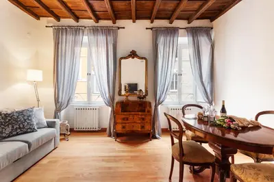 a living room with a table and a mirror at Monti Charming Amphora Apartment in Rome