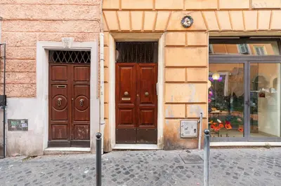 a building with two large wooden doors on a street at Monti Charming Amphora Apartment in Rome