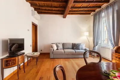 a living room with a couch and a table at Monti Charming Amphora Apartment in Rome