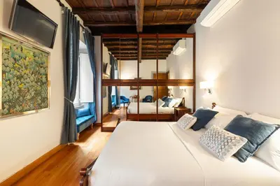 a bedroom with a large white bed with blue pillows at Monti Charming Amphora Apartment in Rome