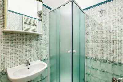 a bathroom with a sink and a glass shower at Prati House in Rome